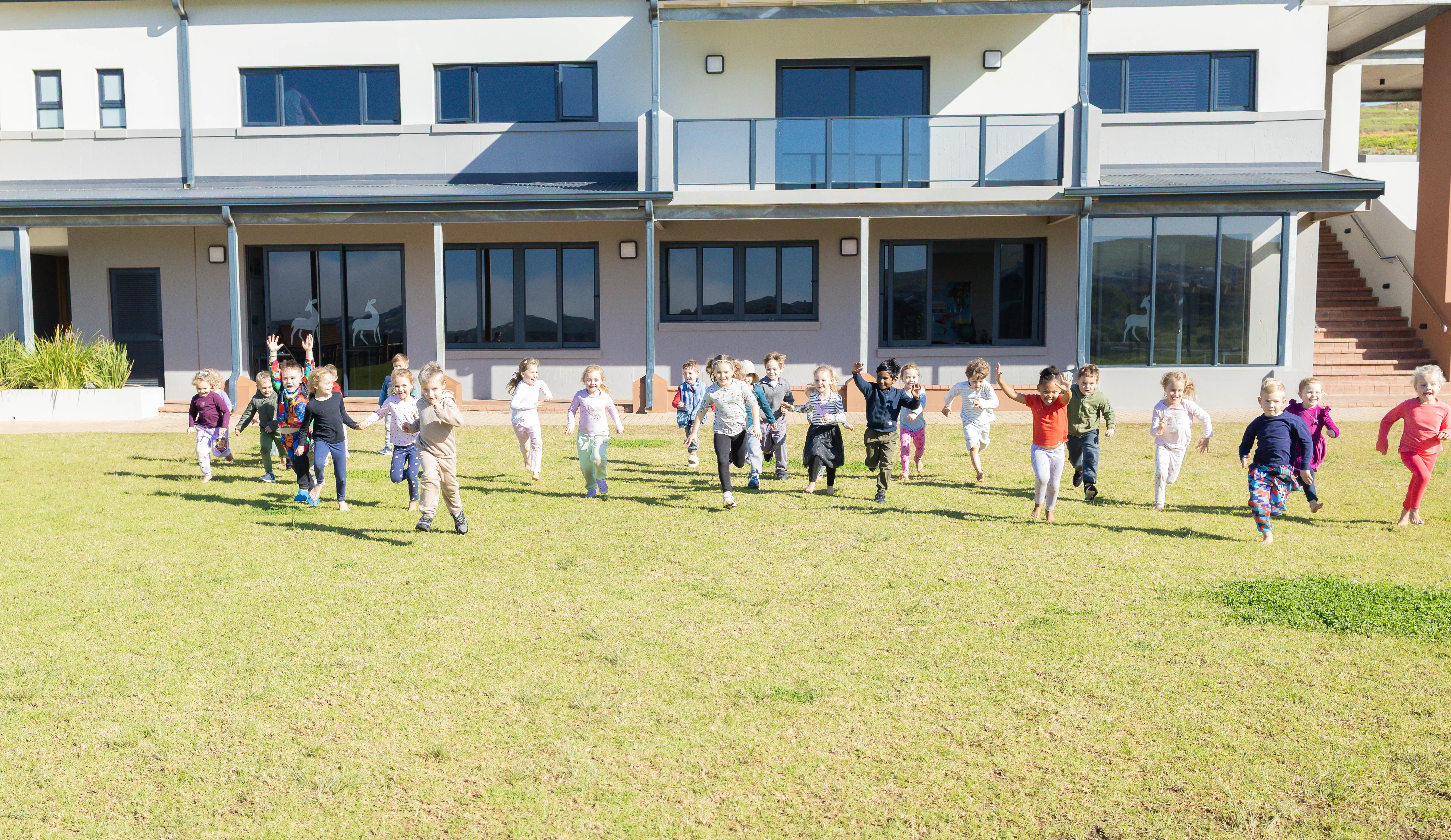 Learners running outside the school at King's College