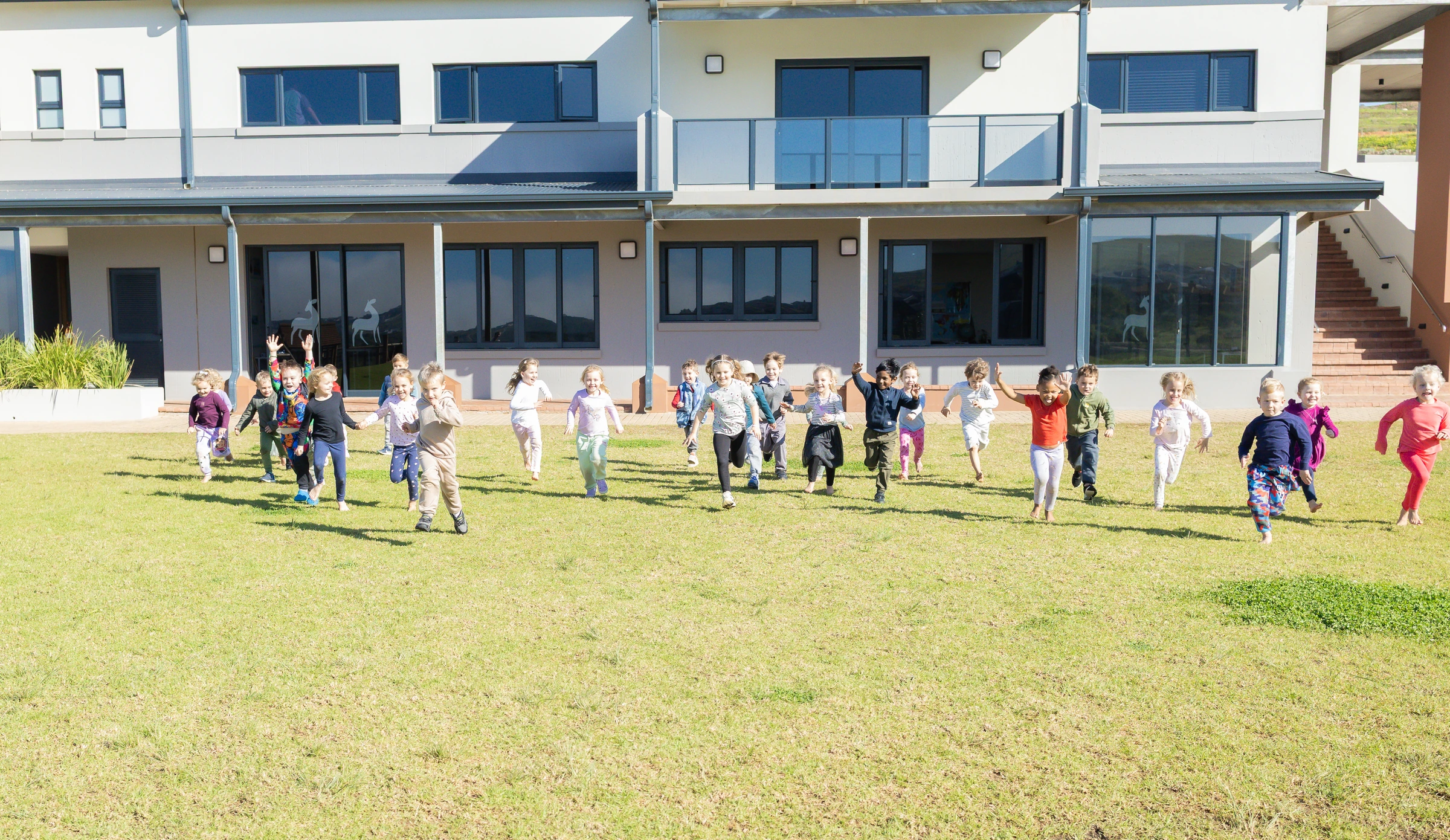Learners running outside the school at King's College