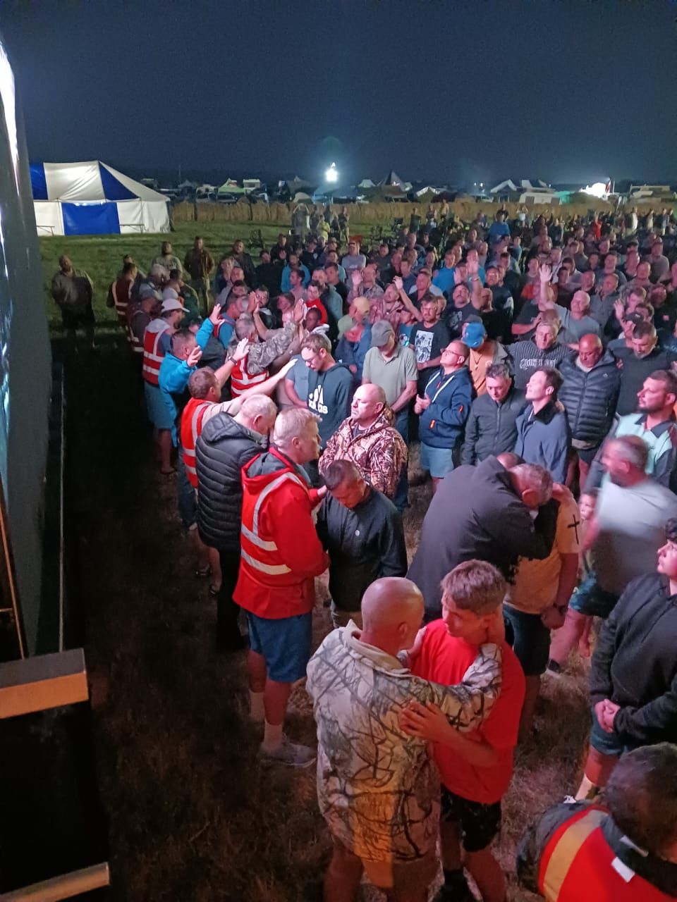 Men praying together at the night session